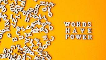 Letters scattered on a surface with some spelling Words Have Power